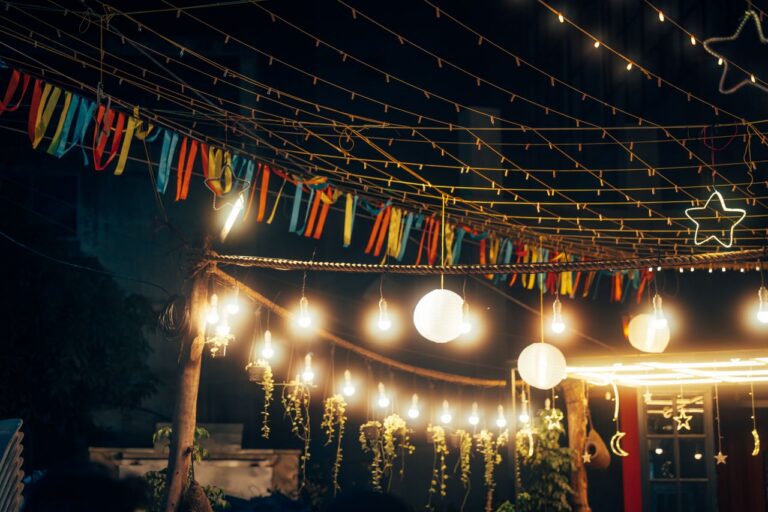 Outdoor string lights and decorations create a festive nighttime ambiance.